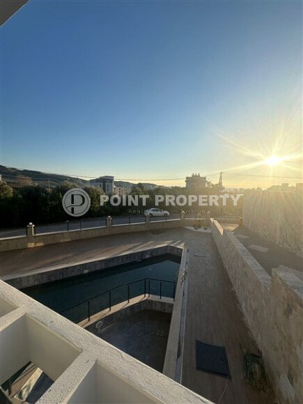 Квартира 1+1 с частичным видом на море в районе Демирташ-id-9498-фото-11