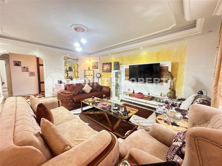 A bright furnished apartment with a functional layout and a balcony converted into a full-fledged living area.-id-9815-photo-1