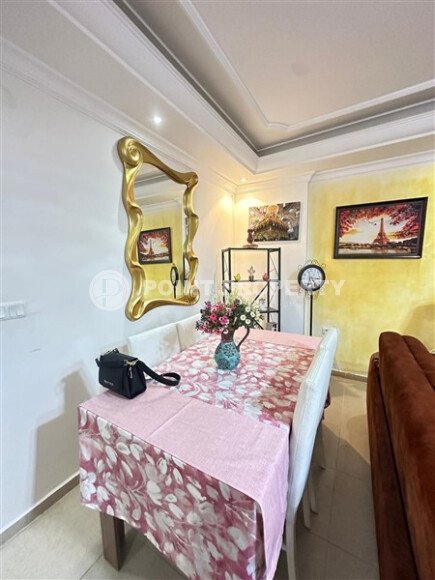 A bright furnished apartment with a functional layout and a balcony converted into a full-fledged living area.-id-9815-photo-9