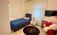 A bright furnished apartment with a functional layout and a balcony converted into a full-fledged living area.-id-9815-photo-13