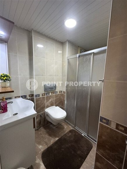 A bright furnished apartment with a functional layout and a balcony converted into a full-fledged living area.-id-9815-photo-16