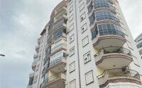 A bright furnished apartment with a functional layout and a balcony converted into a full-fledged living area.-id-9815-photo-18