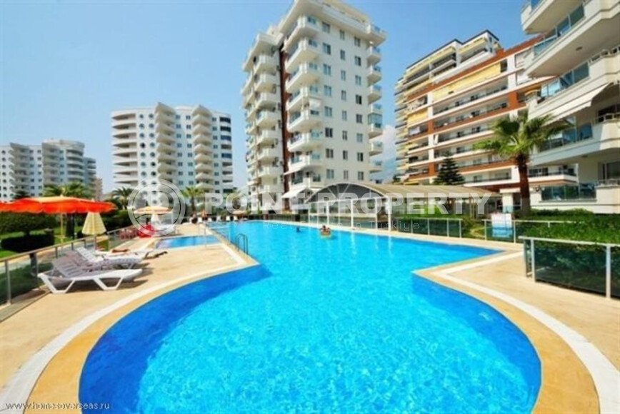 Район Махмутлар. Квартира 2+1, 115 м², 2015 года, до моря 800 м, до центра 500 м, меблирована, с двумя балконами и видом на бассейн.-id-9913-фото-1