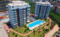 Район Махмутлар. Квартира 2+1, 115 м², 2015 года, до моря 800 м, до центра 500 м, меблирована, с двумя балконами и видом на бассейн.-id-9913-фото-3