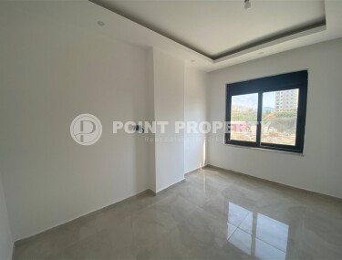 New bright 1+1 apartment of 50 m² in a modern residential complex with a swimming pool and partial sea view in Mahmutlar-id-10228-photo-3