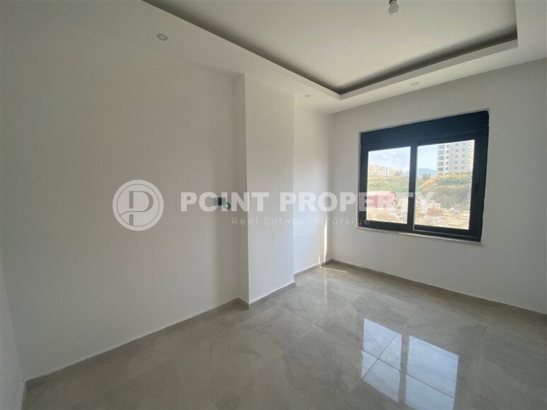 New bright 1+1 apartment of 50 m² in a modern residential complex with a swimming pool and partial sea view in Mahmutlar-id-10228-photo-3