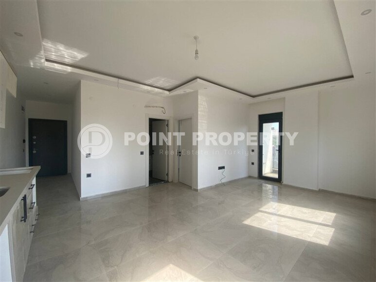 New bright 1+1 apartment of 50 m² in a modern residential complex with a swimming pool and partial sea view in Mahmutlar-id-10228-photo-5