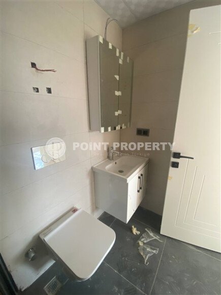 New bright 1+1 apartment of 50 m² in a modern residential complex with a swimming pool and partial sea view in Mahmutlar-id-10228-photo-7