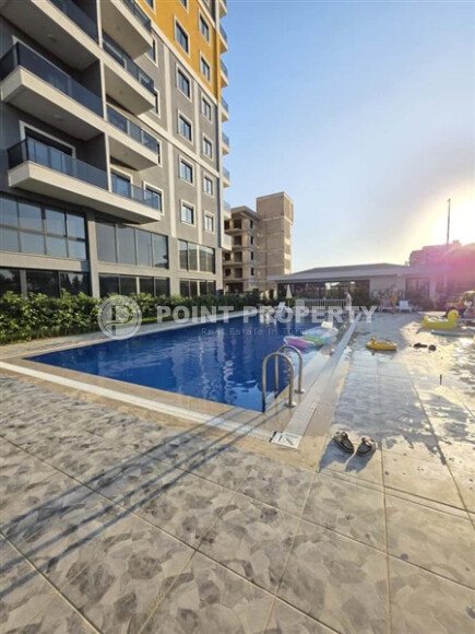 A spacious 1+1 apartment of 59 m² with sea and mountain views in a comfort-class complex in Mahmutlar-id-10229-photo-1