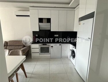 A bright, furnished 56 m² apartment with views of the infrastructure in a modern complex in Mahmutlar-id-10261-photo-3