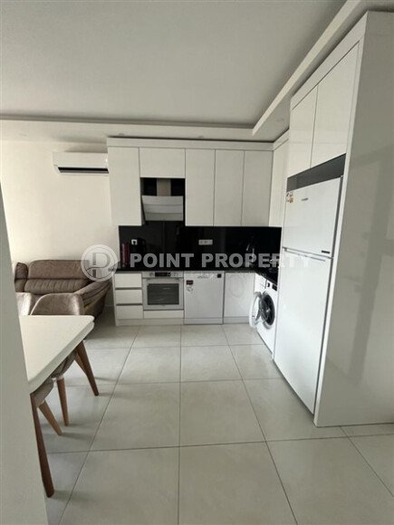 Светлая меблированная квартира 56 м² с видом на инфраструктуру в современном комплексе в Махмутларе-id-10261-фото-3