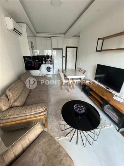 Светлая меблированная квартира 56 м² с видом на инфраструктуру в современном комплексе в Махмутларе-id-10261-фото-4