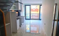 Двухуровневая квартира 55 м² на первой линии в Махмутларе-id-10484-фото-3