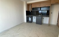 Светлая квартира 50 м² с панорамными окнами и видом на море, район Махмутлар-id-10581-photo-9