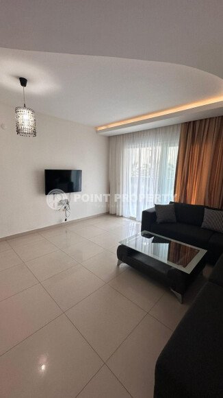 1+1 apartment of 70 m² in Mahmutlar with furniture and a glazed balcony-id-10928-photo-2
