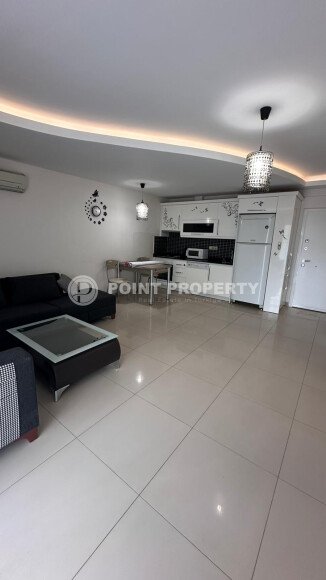 1+1 apartment of 70 m² in Mahmutlar with furniture and a glazed balcony-id-10928-photo-3