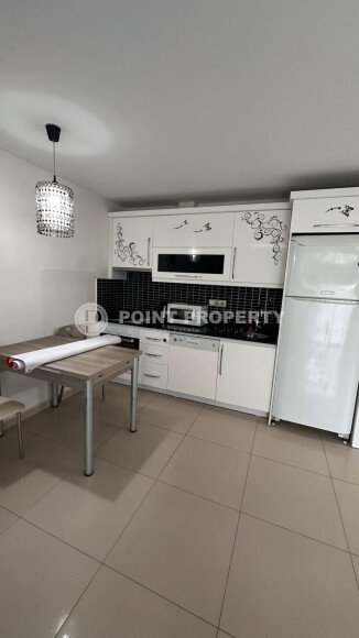 1+1 apartment of 70 m² in Mahmutlar with furniture and a glazed balcony-id-10928-photo-4